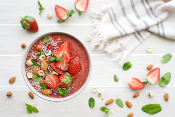 Smoothie bowl with  strawberry, nuts, coconut and chia seeds. Flat lay Healthy lifestyle, healthy...