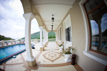 Fisheye view of the luxury house with a swimming pool among the Crimean mountains