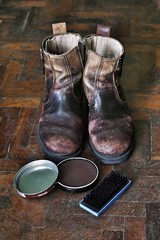 Vintage shoes on wooden floor, shoe polish and brush