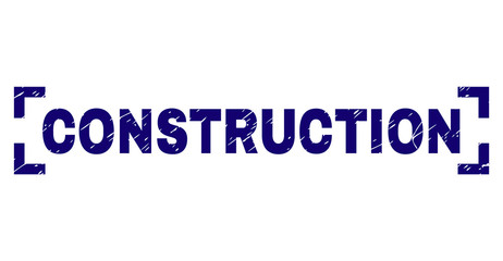 CONSTRUCTION text seal print with grunge effect. Text tag is placed inside corners. Blue vector rubber print of CONSTRUCTION with dust texture.