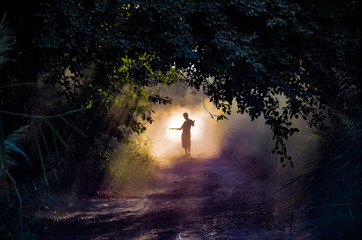 man silhouette in the fog at forest 