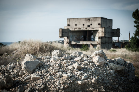 ruins of building construction in war conflict or natural disaster zone with copyspace