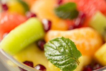 Healthy fresh fruit salad as a background.