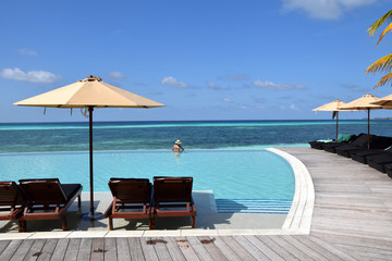 Beautiful woman relaxing  in swimming pool.