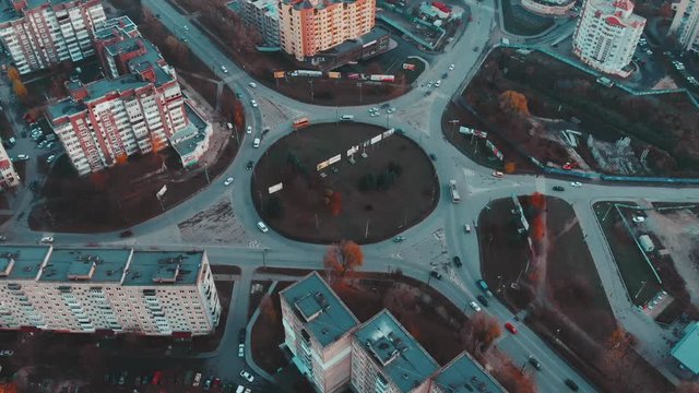 Aerial view to the road circle with city cars traffic 4k cinematic color, side view