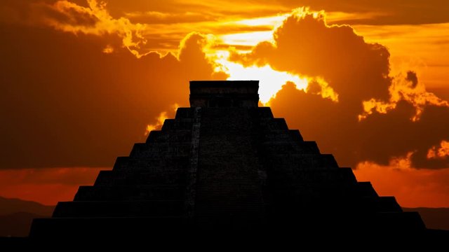 Mayan pyramid ( Kukulcan Temple ) at Sunset, Time Lapse with Red Sun and Clouds, Chichen Itza, Yucatan, Mexico