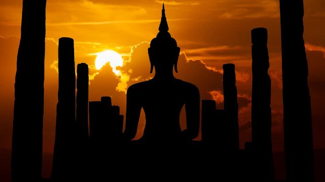 Antique Statue of Buddah at Sunset in Time Lapse with Sun Red Clouds, Bangkok, Thailand