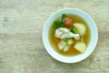 boiled chicken leg with potato soup on bowl
