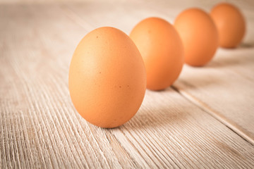 Chicken eggs on a wooden table. Selective focus.
