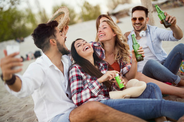 Group of cheerful friends having great time at beach