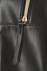 Zipper, lightning on black leather