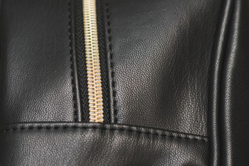 Zipper, lightning on black leather