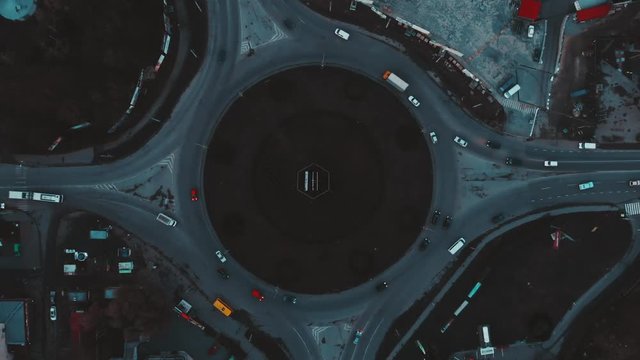 Aerial view to the road circle with city cars traffic 4k cinematic color, top view, Ternopil, Ukraine
