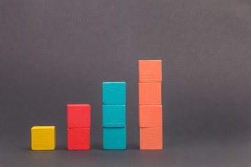 Toy wooden blocks as financial graph. Graph with four 4 steps. Growing chart. Infographic diagram,...