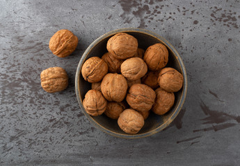 Bowl of walnuts with two to the side