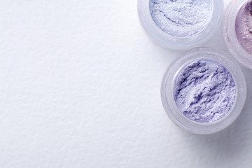  jars of pigment spring pastel colours on a white textured background