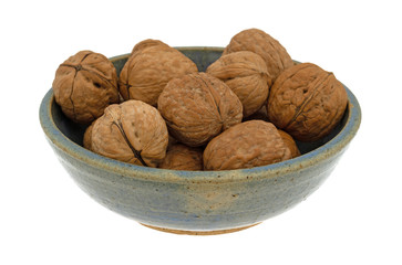 Bowl of walnuts isolated on a white background side view