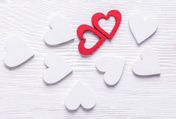 Two red and white hearts on a white wooden background. Valentine's Day