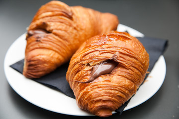 Croissant with chocolate on the plate