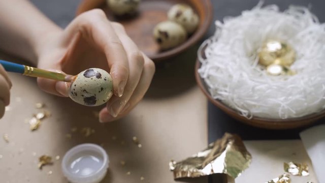 Decoration of Easter eggs with gold foil