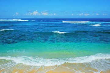 Beach and beautiful tropical sea. Caribbean summer sea with blue water. White clouds on a blue sky over summer sea. Tropical sea relax.