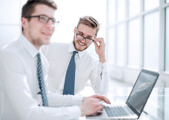 close up.two successful employees sitting at the Desk