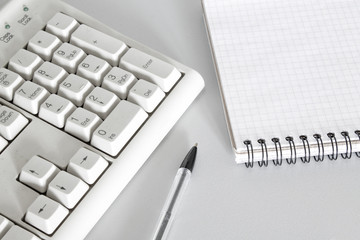 pen, keyboard and notebook closeup