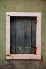 Obraz na płótnie Canvas Old building in Venice, Italy. Vintage window with rusty decorative bars