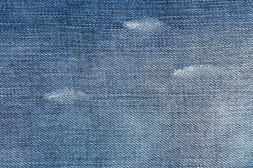 Ripped blue jeans with a hole texture background