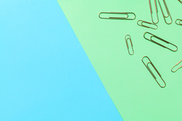metal paper clips and paper on paper background