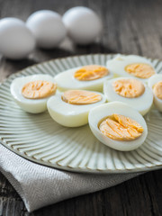 Boiled chicken eggs on a gray plate. Wooden background. The concept of Easter