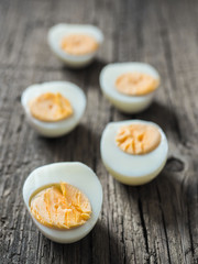 Boiled chicken eggs on wooden background. The concept of Easter