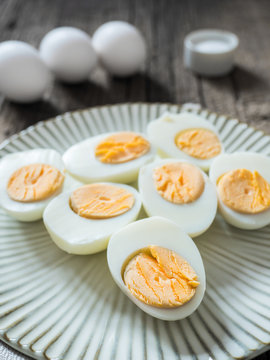 Boiled chicken eggs on a gray plate. Wooden background. The concept of Easter