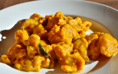Pumpkin gnocchi with nutmeg seasoned with butter and sage