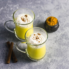 Turmeric golden milk latte. Selective focus, space for text.