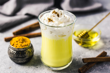 Golden milk honey ginger drink. Selective focus, space for text.