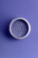 jar with pigment fashionable shade blue on a colored background