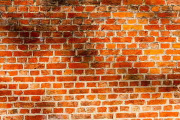 red brick wall texture grunge background with vignetted corners, may use to interior design. Old orange brick.