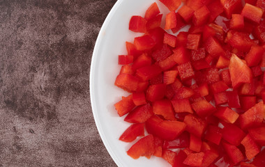 Chopped red bell peppers on a white plate