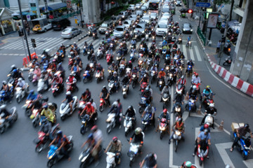 Traffic jam Bangkok.  Motorcycle taxi drivers push to the front of a line.
