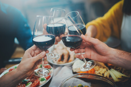 Close up image of best friends making cheers with wine glasses during birthday party at restaurant, happy family celebrating anniversary at home, Friendship Dinner Holidays Concept