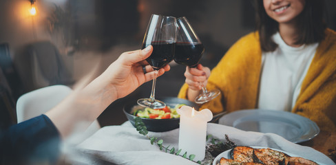 Romantic dinner concept, cropped image of happy couple enjoying healthy food and red wine during romantic dinner by candlelight, Celebration Love Relationship Date Concept