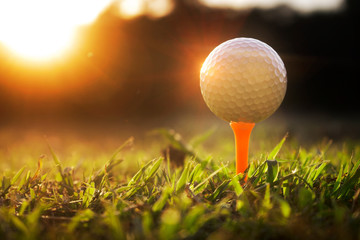 Golf balls on tee in beautiful golf courses with sun rise background