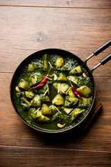 Aloo Palak sabzi or Spinach Potatoes curry served in a bowl. Popular Indian healthy recipe. Selective focus
