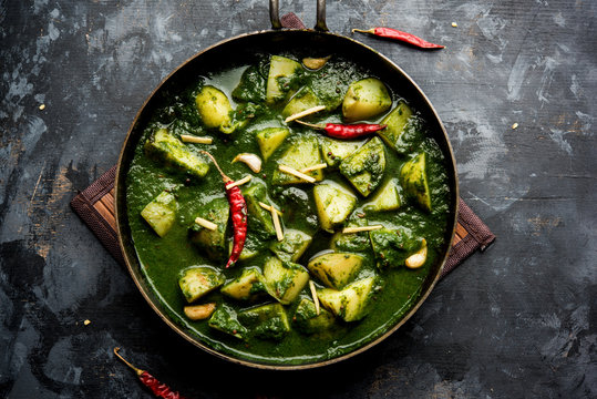 Aloo Palak sabzi or Spinach Potatoes curry served in a bowl. Popular Indian healthy recipe. Selective focus