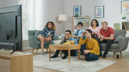 At Home Diverse Group Friends Watching TV Together, Getting Emotionally Terrified and Horrified by the Content of the TV. Young People Are Scared After Watching News or Horror Movies.