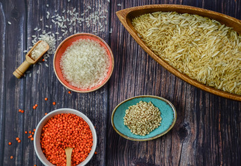various cereals, seeds, beans and grains on wooden table 