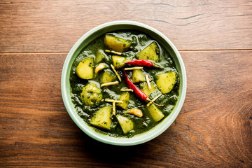 Aloo Palak sabzi or Spinach Potatoes curry served in a bowl. Popular Indian healthy recipe. Selective focus