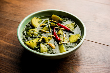 Aloo Palak sabzi or Spinach Potatoes curry served in a bowl. Popular Indian healthy recipe. Selective focus