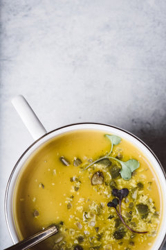 Curried Butternut Squash Soup with Crushed Pumpkin Seeds and Microgreens
